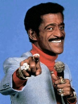 An image of Sammy Davis Jr. with a microphone 