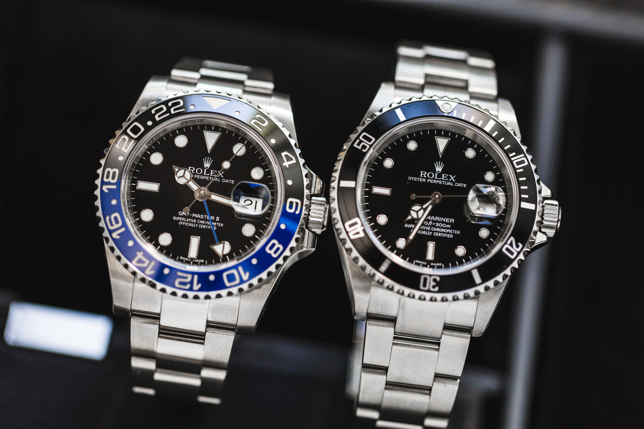 An image of a GMT Master II "Batman" next to a black dial Submariner