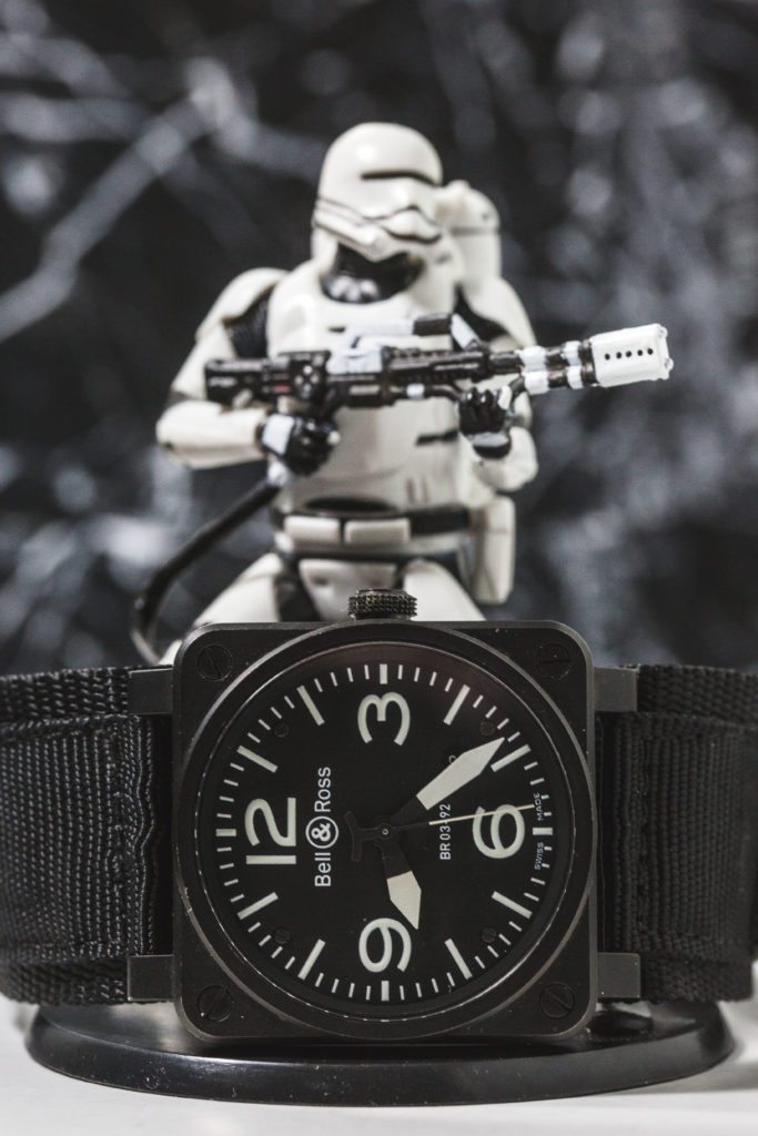 An image of Storm Trooper figurines with a Bell & Ross Aviation Ceramic watch
