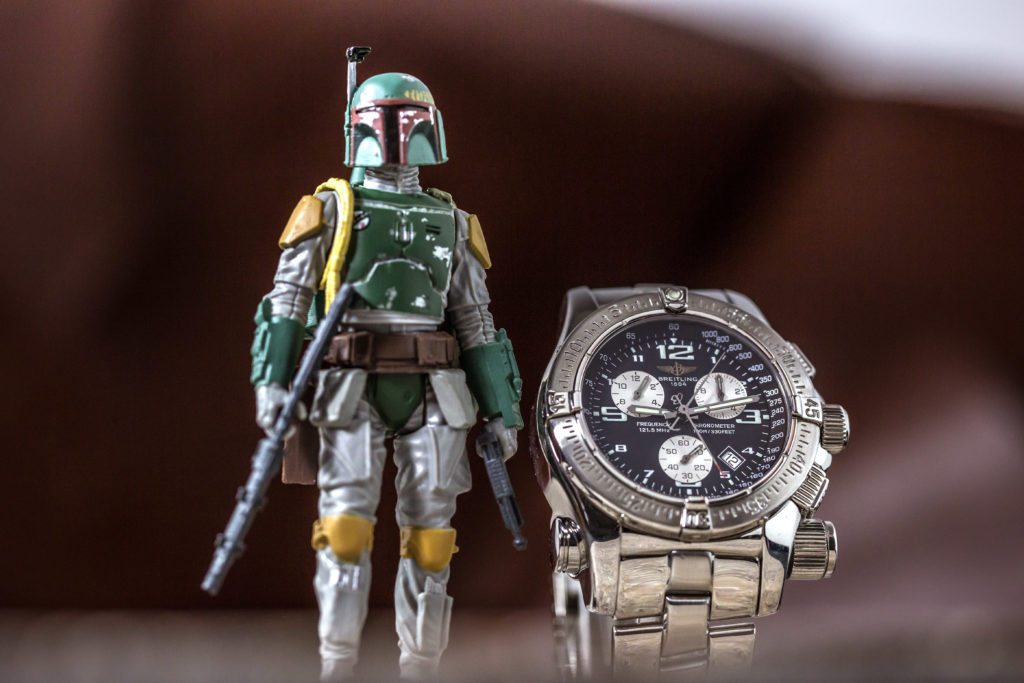 An image of a Boba Fett figurine with a breitling emergency watch 