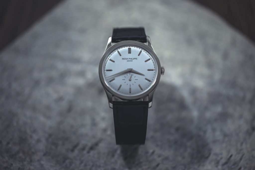 An image of a patek philippe dress watch on stone