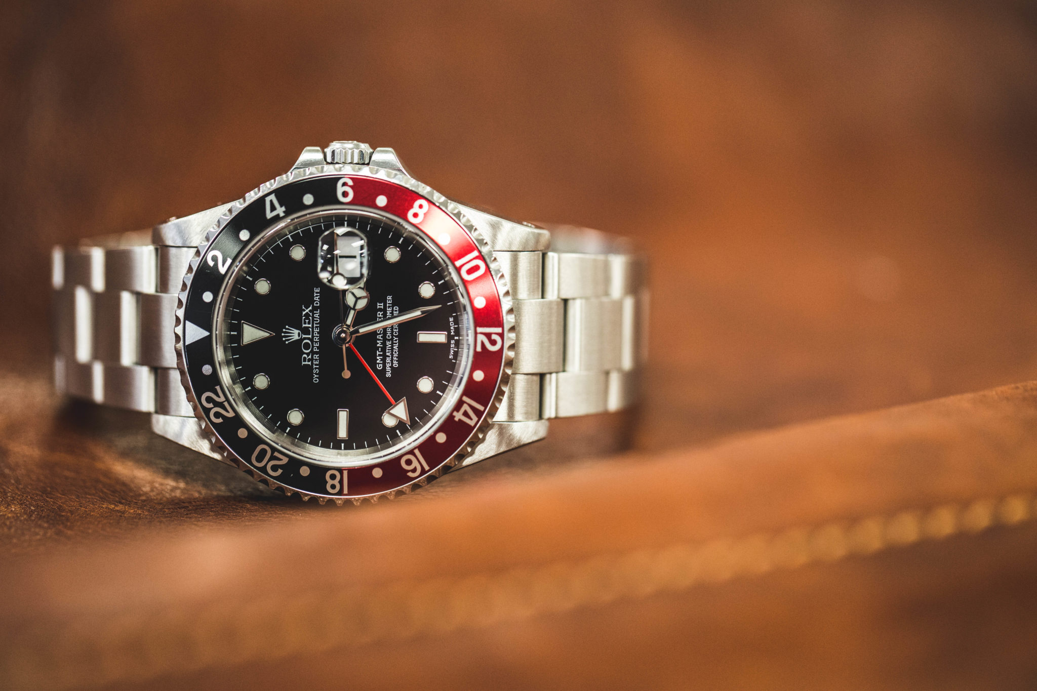 A Rolex GMT Master II with a red and black dial 
