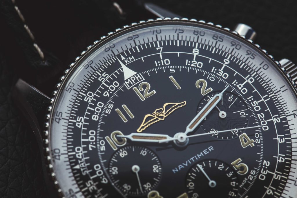 Breitling vs. Rolex: An image of a Breitling Navitimer with a blue and white dial 