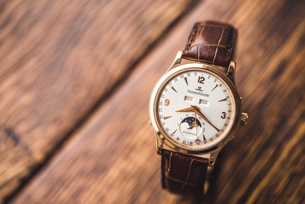A JLC dress watch with a moonphase and gold case with Dauphine watch hands 