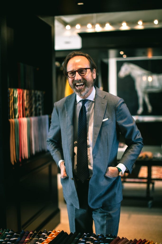 A Portrait of Sid Mashburn in a suit in his store