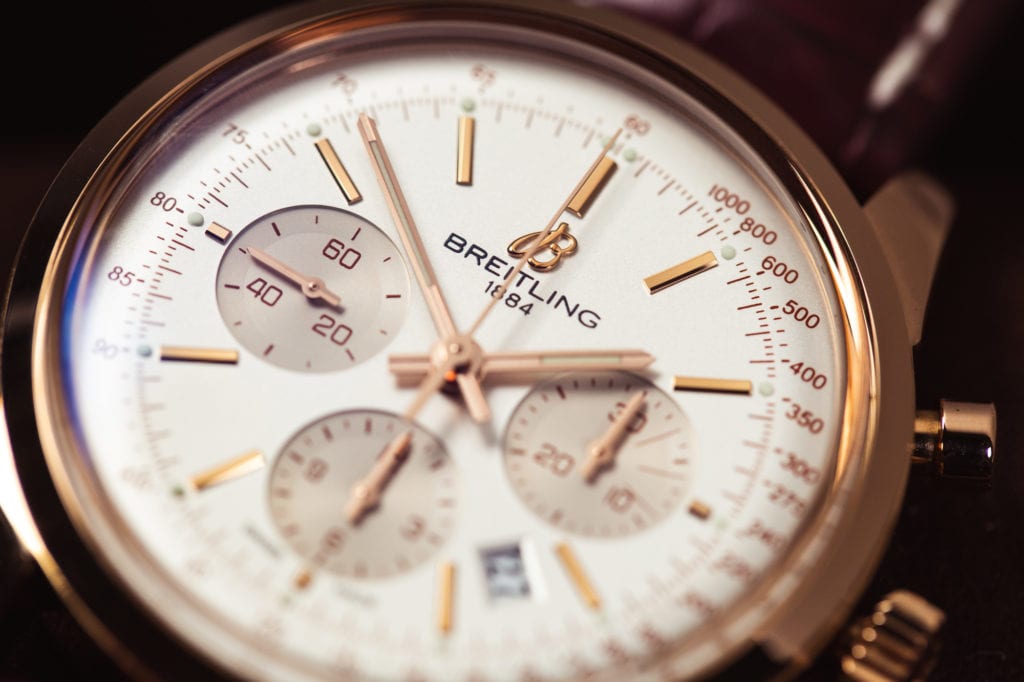 A Breitling Transocean with a gold case and leather strap