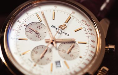 A Breitling Transocean with a gold case and leather strap
