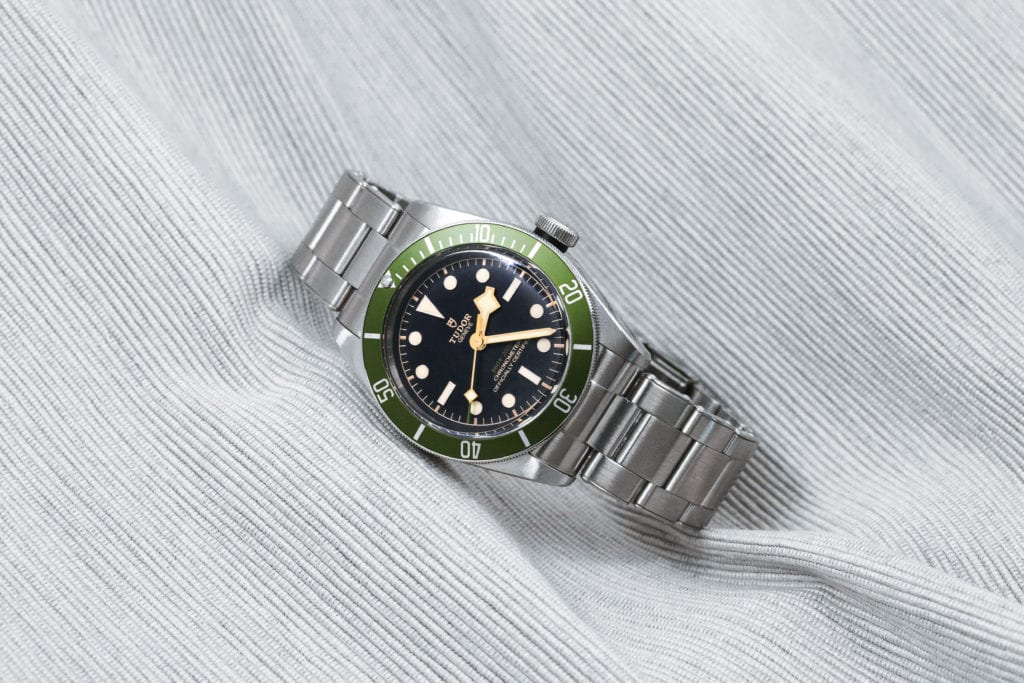 The Evolution of Tudor's Snowflake Hands - a Black Bay watch with a green bezel 